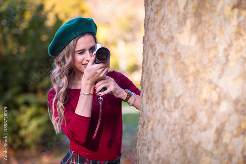Pretty woman with vintage video camera