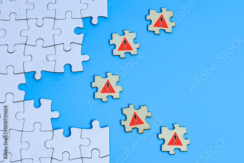 Business Risk concept with Incomplete Jigsaw Puzzle and Warning Symbols 