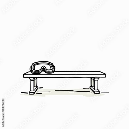 Ski goggles resting on simple wooden bench  
