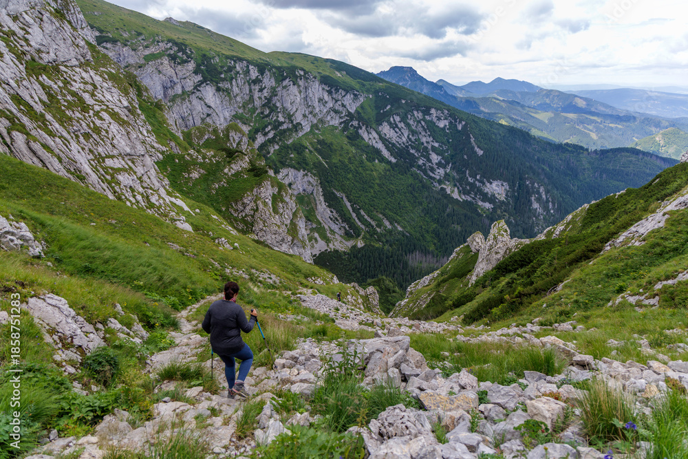 Fototapeta premium Hiker Descending Steep Rocky Trail in High Tatras