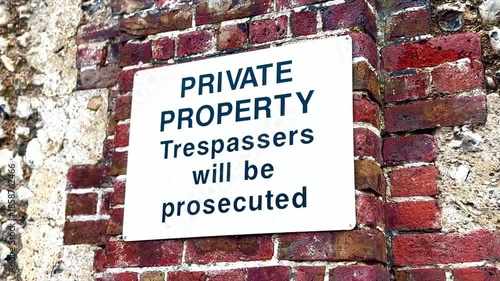 private property trespassers will be prosecuted white sign on brick wall