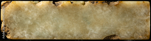 cracked weathered jade slab dominates frame set warm golden light accentuates jagged edges dark