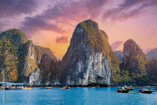 Tableau sur toile Scenic Halong bay at sunset with limestone karsts and touristic boats, Vietnam