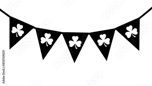 Black bunting flags with white shamrocks hanging on a string.