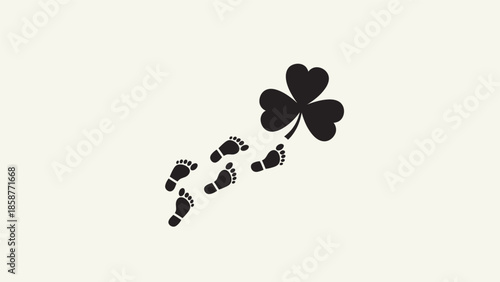 Black footprints leading to a four-leaf clover symbolizing good luck.