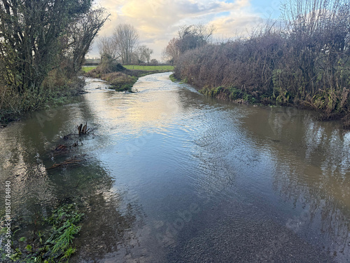Flooded lane  caused by stream which has burst its banks in winter after heavy rain, East Chinnock, Somerset, UK