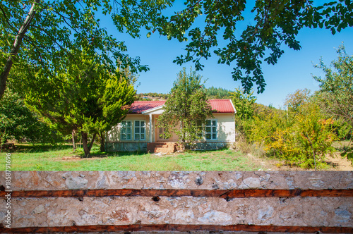 A single-story detached house in a garden.