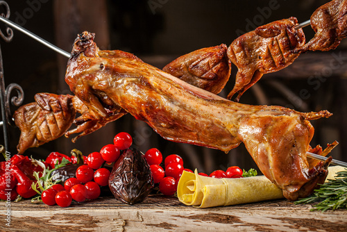 Whole roasted rabbit with quail on spit