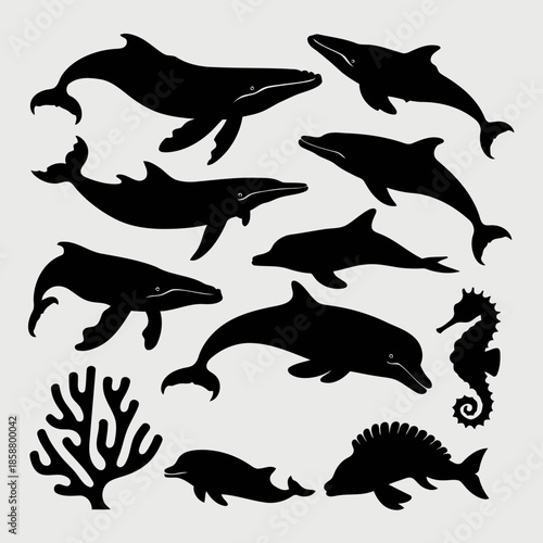 Collection of various marine animals including whales, dolphins, seahorse, fish, and coral in black silhouette style