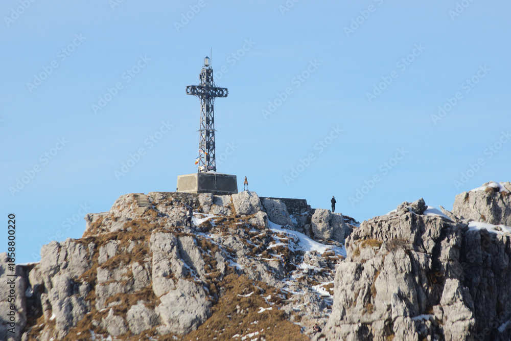 Fototapeta premium The sharp rocks and the summit cross of Mount Resegone, a popular hiking and climbing destination in the Italian Alps