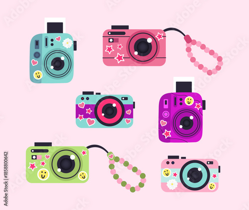 Illustration of cute cameras with stickers on a light pink background.