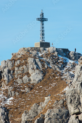 The sharp rocks and the summit cross of Mount Resegone, a popular hiking and climbing destination in the Italian Alps
