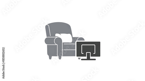 A grey armchair with a white cushion sits next to a dark grey television screen on a stand