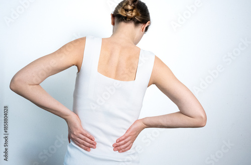 Woman suffering from lower back pain, rear view