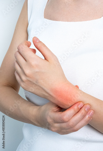 Woman holding arm with pain highlight concept