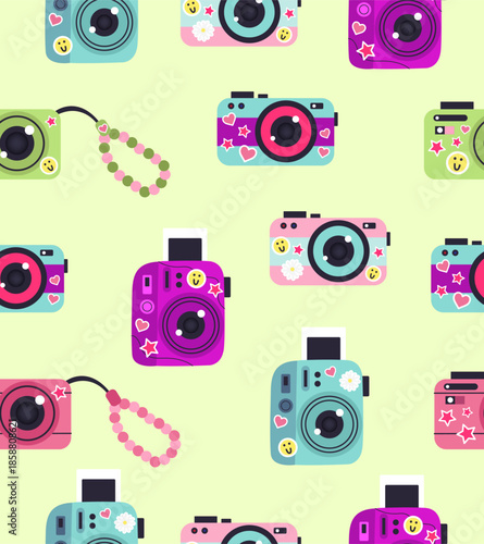 Pattern of cameras with stickers on a light green background.