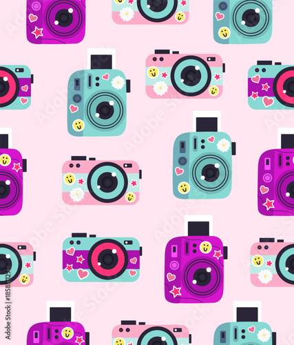 Pattern of cameras with stickers on a light pink background.