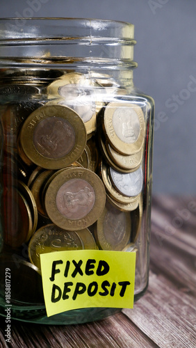 Kolkata, India, dated 28.12.2025. Glass Jar with Indian Rupee Coins Representing Savings, FD and SIP Investments