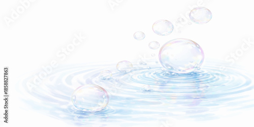 A macro photo captures a clear, transparent water drop on a clean blue background, resembling a sphere of liquid light