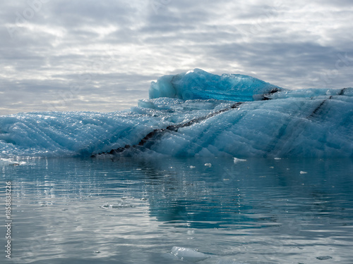 Wallpaper Mural Blue iceberg glistening in sunlight floating in Iceland's Jokulsarlon Glacier Lagoon Torontodigital.ca