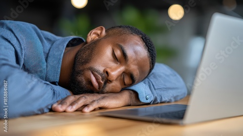 Exhausted office worker sleeping at desk from work fatigue
