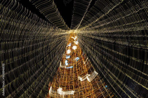 Christmas tree made with colored lights and long exposure. The effect of movement.