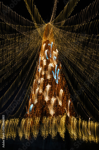 Christmas tree made with colored lights and long exposure. The effect of movement.