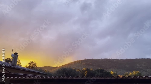 Rural house rooftop at sunset with mountain landscape view