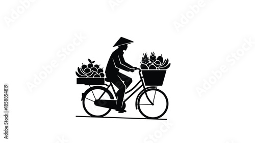 Silhouette of a person in a conical hat riding a bicycle, carrying baskets brimming with various fruits