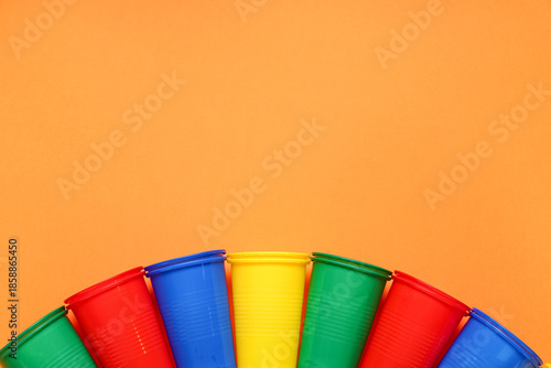 Colorful plastic cups on or...