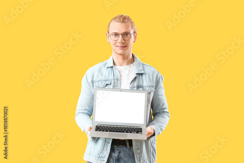 Young man with blank laptop...