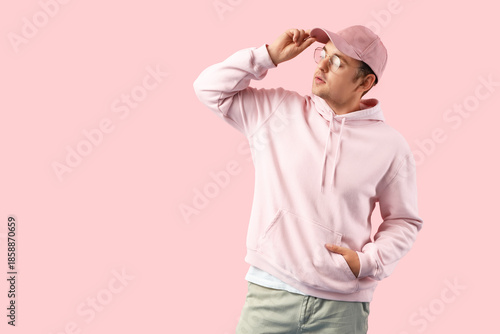 Stylish young man in hoodie...