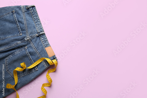 Jeans with measuring tape o...