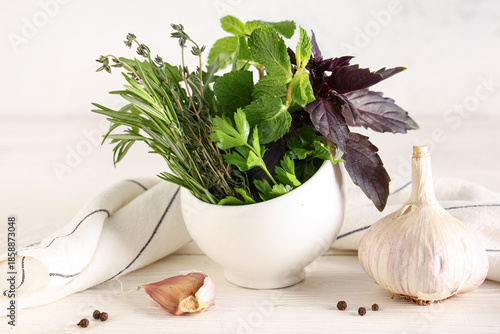 Mortar with fresh herbs, sp...
