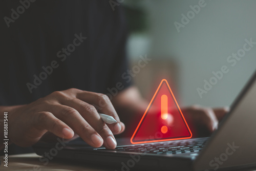 Cyber security warning concept with person typing on laptop, showing alert symbol and data risk notification. Cybersecurity, system error, data protection, hacking prevention, IT security services.