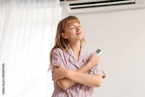Young woman near air condit...