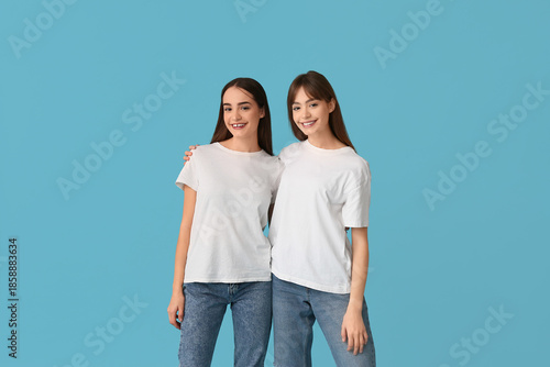 Happy young twin sisters on...