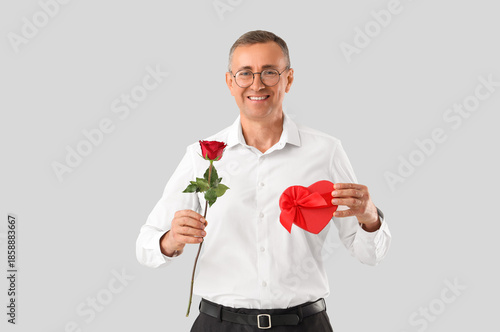 Happy mature man with rose ...