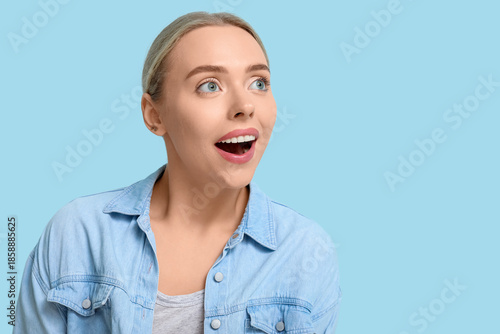 Cheerful young woman on blu...
