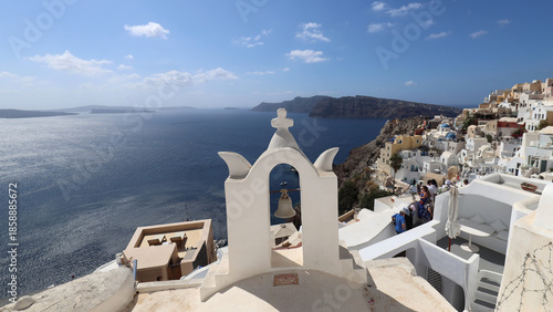 Panorama with white bell tower of Santorini Oia village