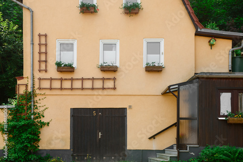 View of house with wooden d...