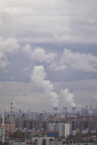 Industrial city skyline with factories emitting smoke into the cloudy sky, air pollution, environmental impact of industry and urban ecology concept