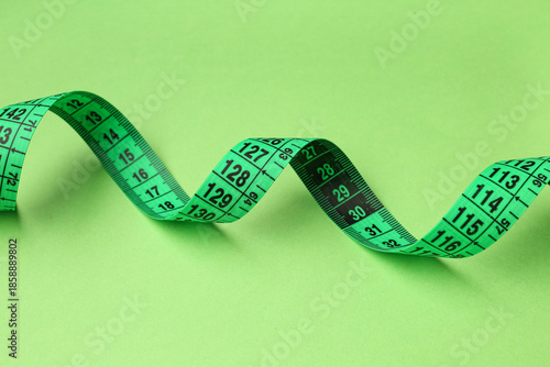 New measuring tape on green...