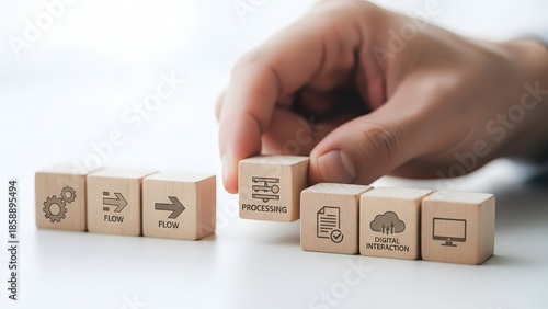 Hand arranging wooden blocks with technology icons on a white background