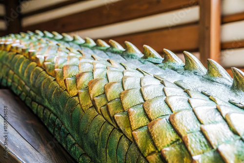 Wallpaper Mural a large green alligator head on a wooden table Torontodigital.ca