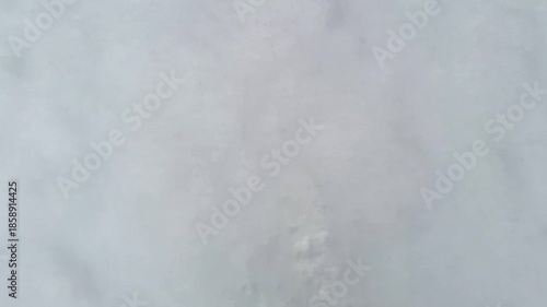 Feet kicking snow. Walk in winter park. Top view of walking legs over white fluffy snow. Point of view slow motion footage. POV video of human steps.