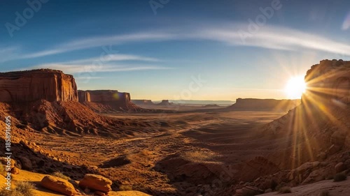 Panoramic view of a desert landscape with a rocky cliff formation during a vibrant sunrise. Perfect for backgrounds, travel brochures, and landscape photography.