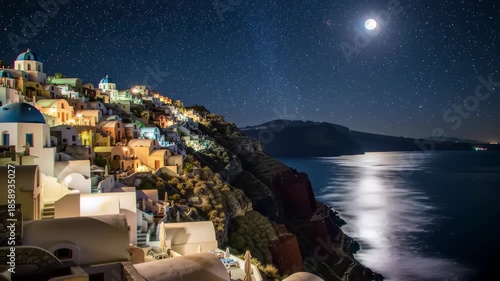 A coastal village at night with a full moon and starry sky
