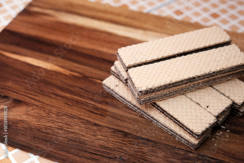 Pile of Wafer filled on wooden board, for Food Copy Space Design. 