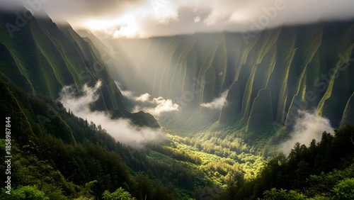 Majestic mountain valley with sun rays and misty clouds